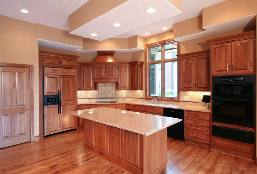 Empty kitchen space with wood cabinets center island countertops