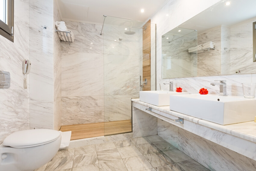 Bathroom with frameless mirror, basin and shower area