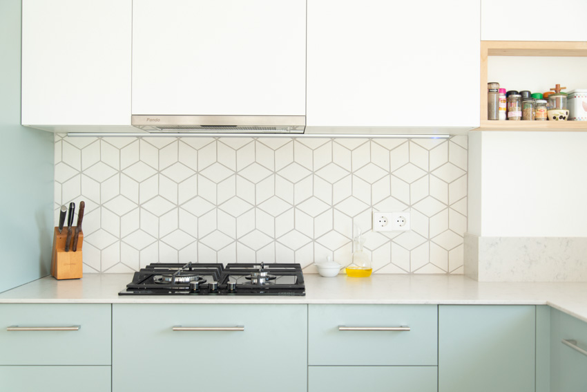 Geometric backsplash countertop light green cabinets kitchen