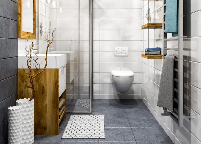 Gray tile floor glass shower area toilet white wall