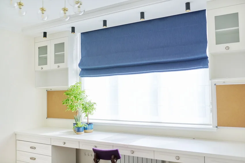 Home workplace interior with blue roman blinds