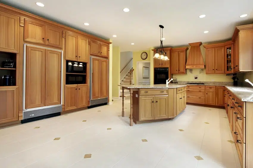 Huge kitchen with wooden cabinets and white tile flooring
