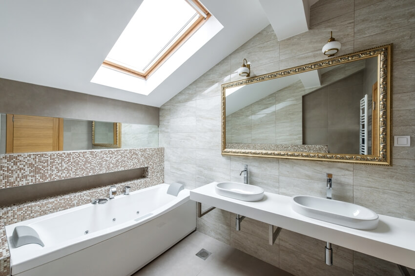 Bathroom with skylight, sloped wall and gilded mirror