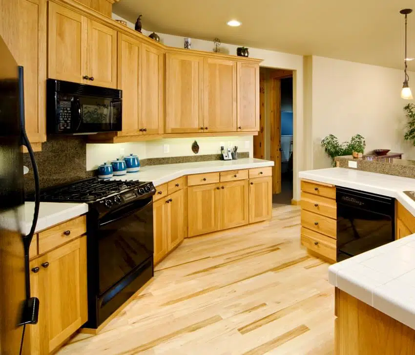 Kitchen with maple cabinets and black appliances
