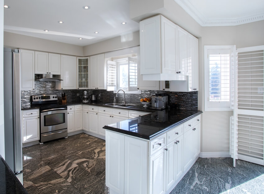 Kitchen area with black marble in irregular pattern