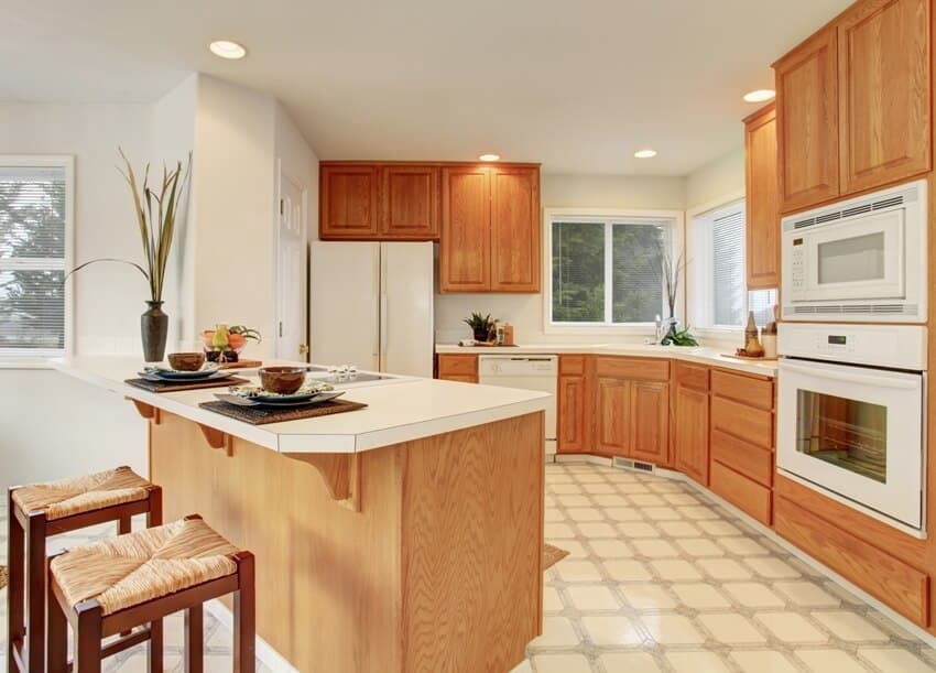 Kitchen interior with tile floor wooden cabinets and white appliances