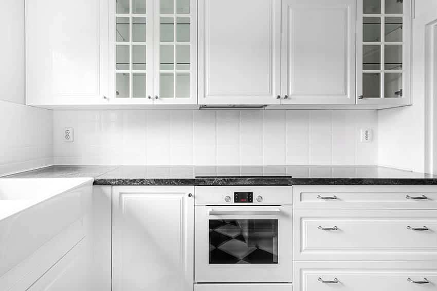 Kitchen with white cabinets glass doors white appliances