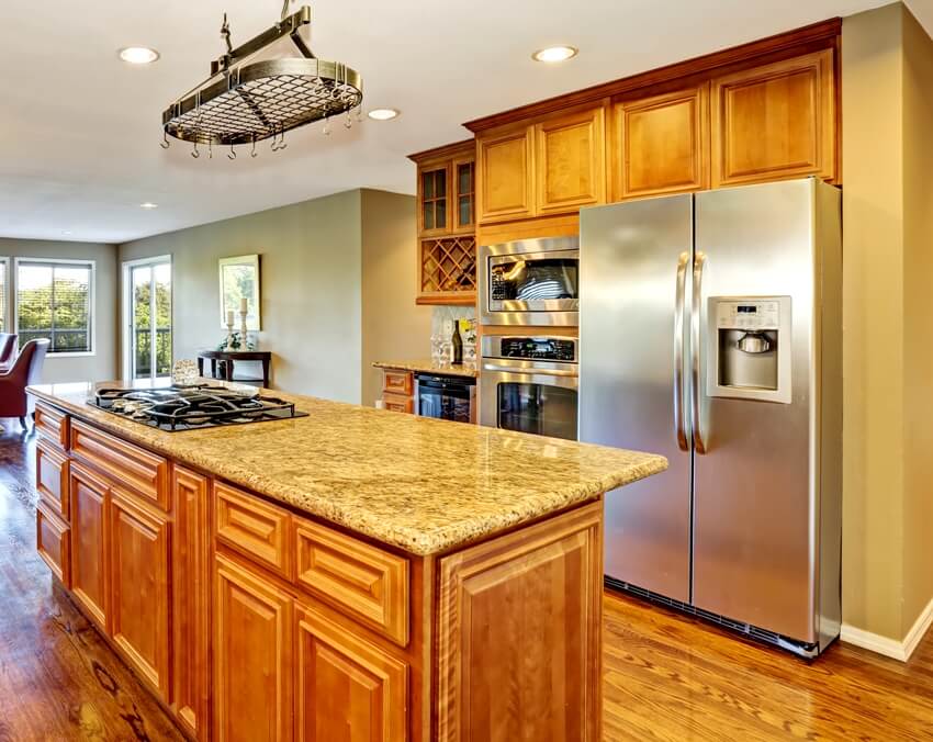 A kitchen with wooden interior and gray walls