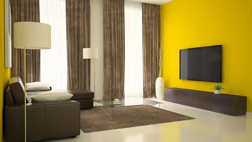 Living room with yellow walls brown curtain television sofa chair lamp