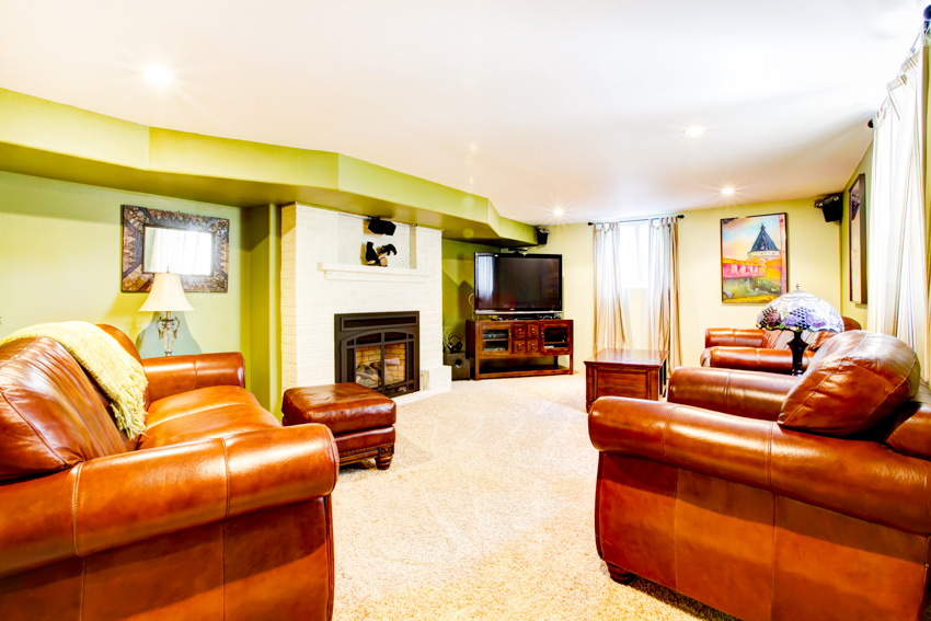 Lime painted walls with neutral curtains and tan upholstery