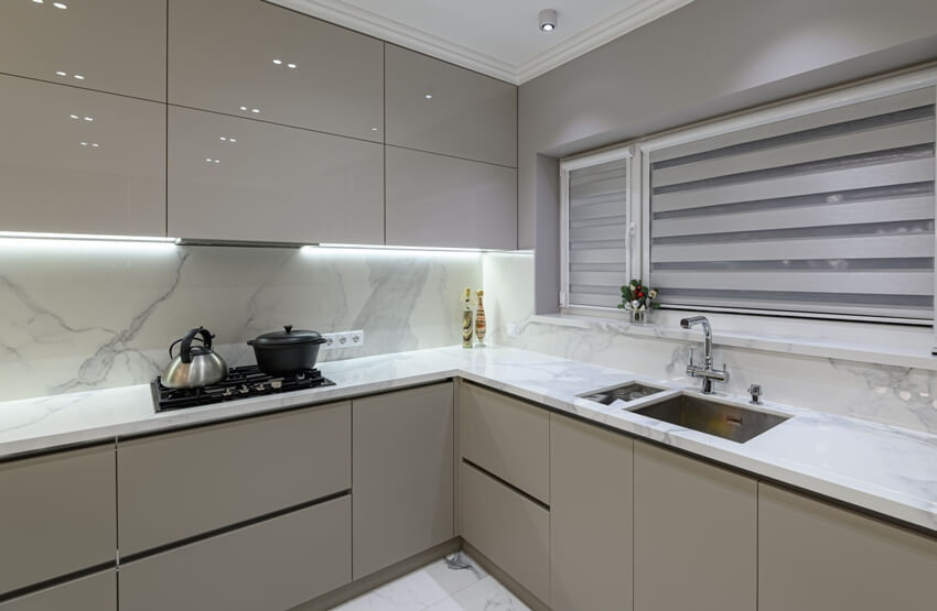 Luxury large modern white marble kitchen with beige handleless cabinets