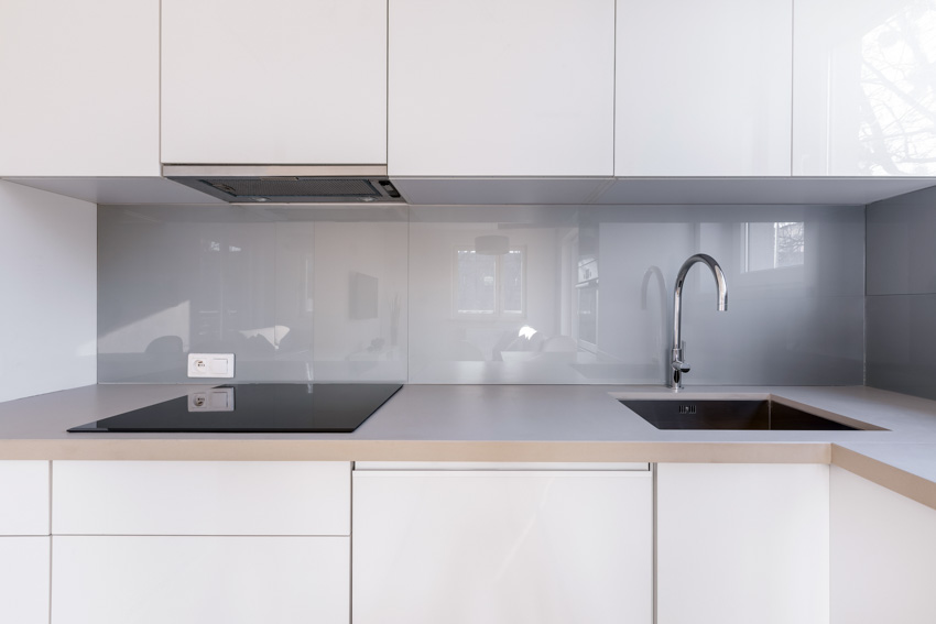 Matching countertop backsplash sink stove white cabinets