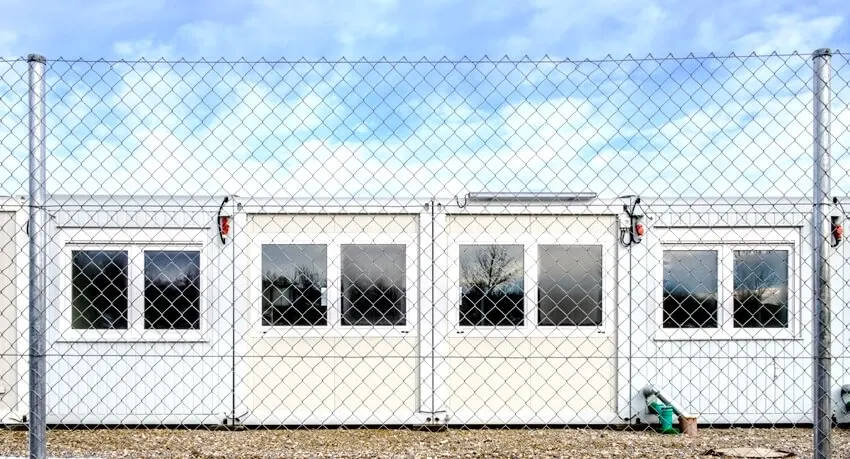 Mobile home container with chain link fence