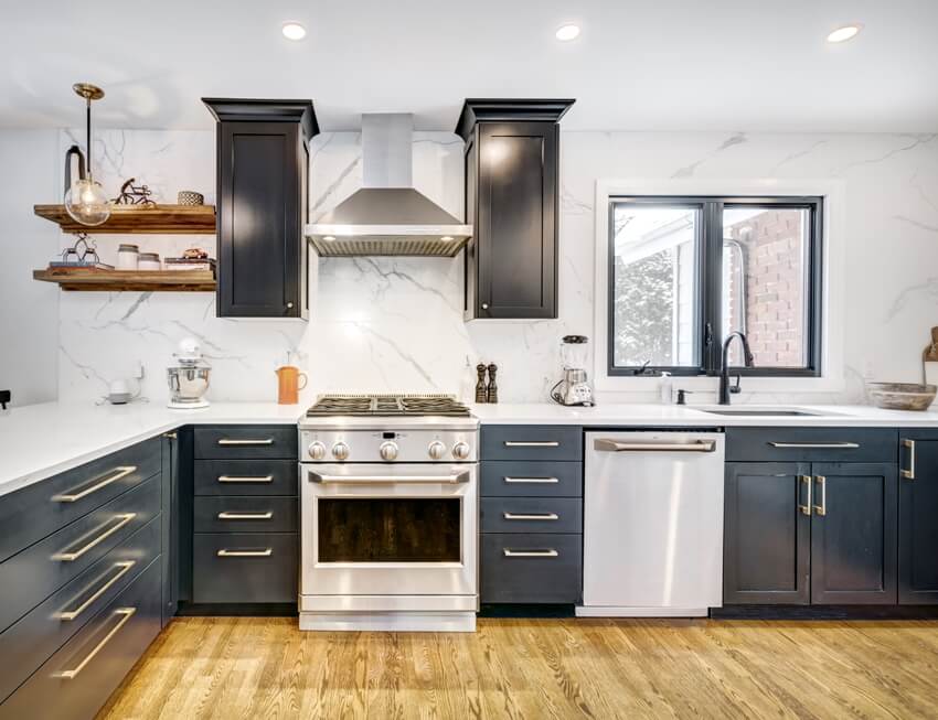 Kitchen with black cabinets, chrome handles and hood