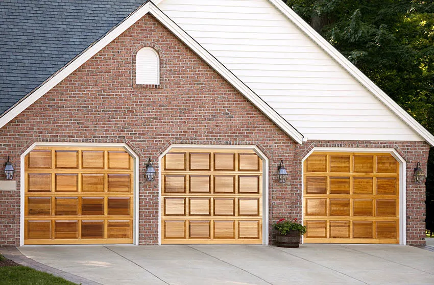 Modern garage with brick and vinyl sidings and wood doors