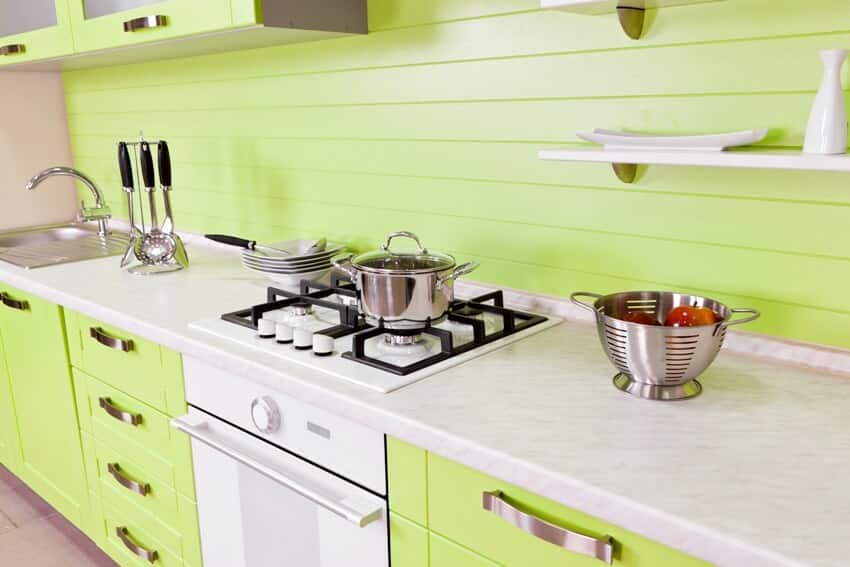 Modern kitchen with bright green cabinets and counter with food preparation