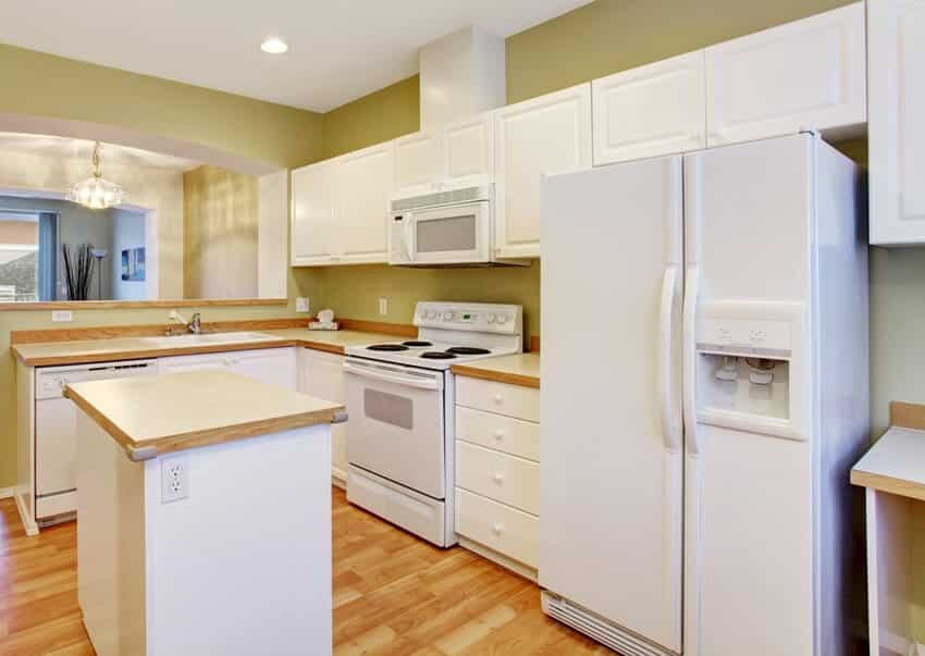 Modern kitchen with hardwood floor kitchen island white cabinets and appliances