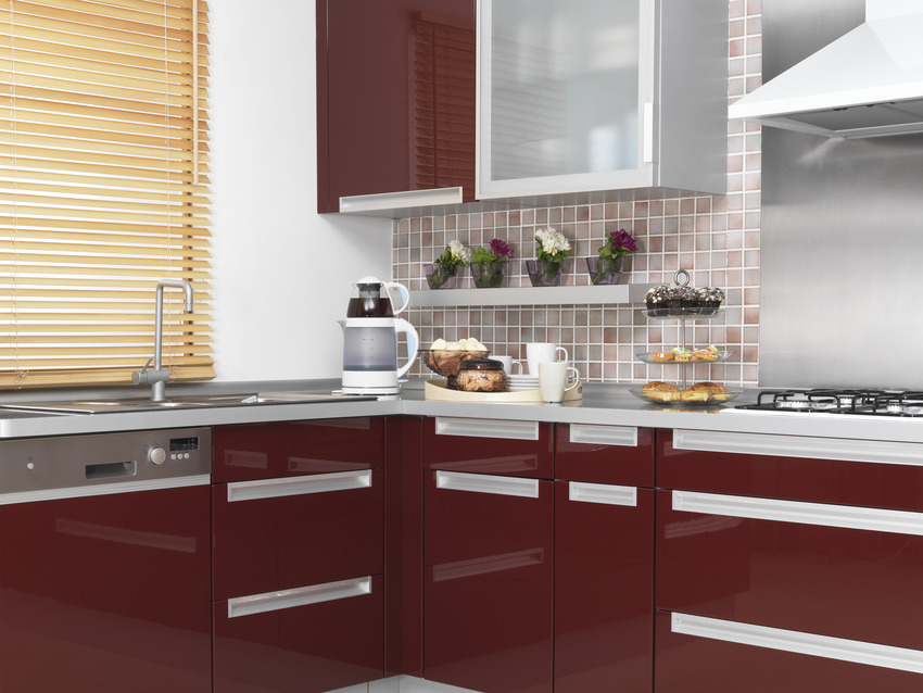 kitchen with red acrylic cabinets and stainless steel sink