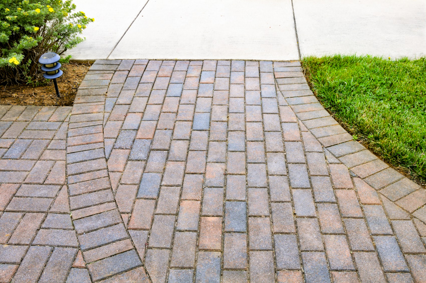 Multi colored bricks leading to concrete walkway