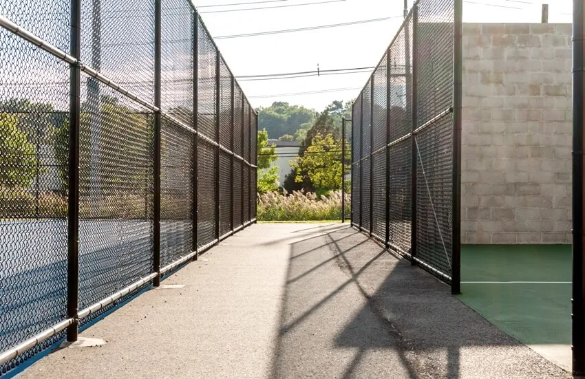Outdoor sports and fitness area with black chain link fence