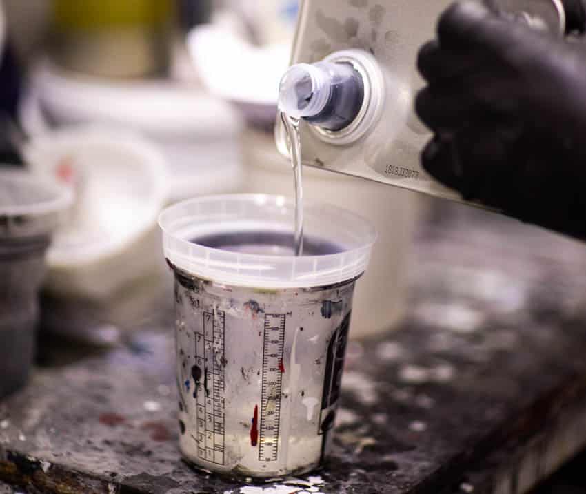 Paint thinner being poured in container