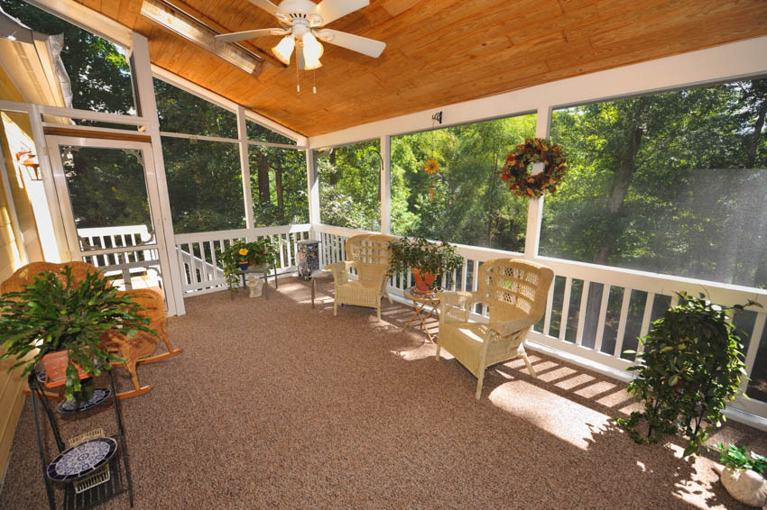 Porch turned into a room with indoor plants ceiling plants chairs