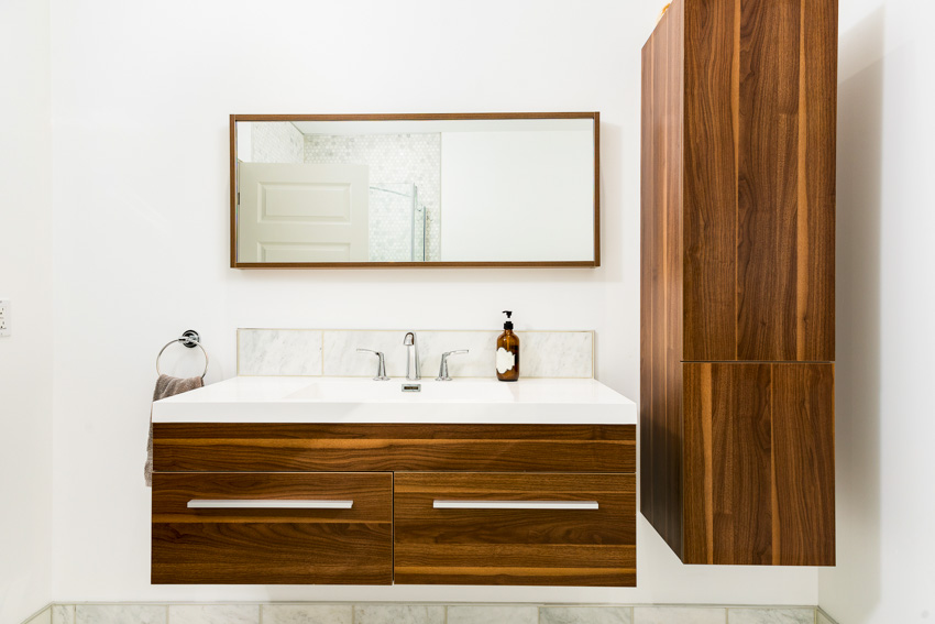 Rectangular mirror and wood cabinet drawers