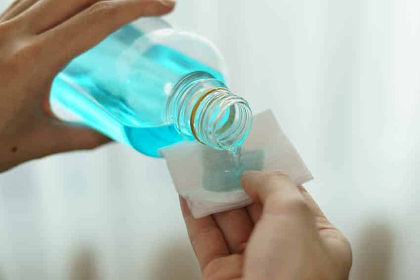 Rubbing alcohol being poured on tissue