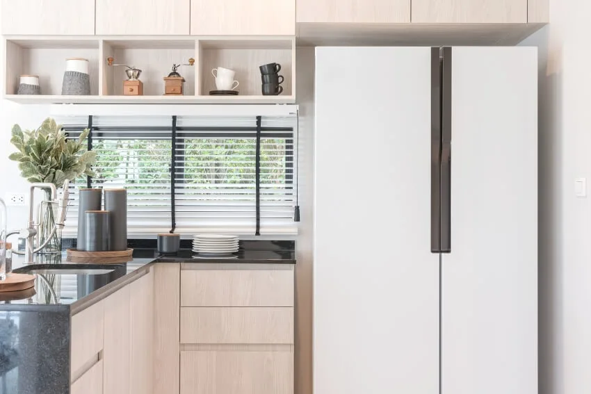 Scandinavian interior design of new decorated wooden kitchen in luxury home with black granite counter top