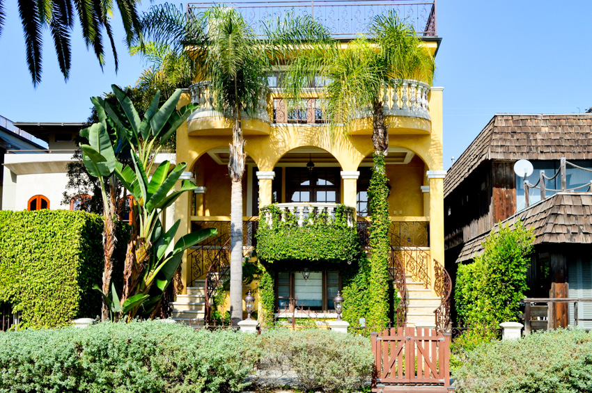 Spanish style house with yellow exterior paint color