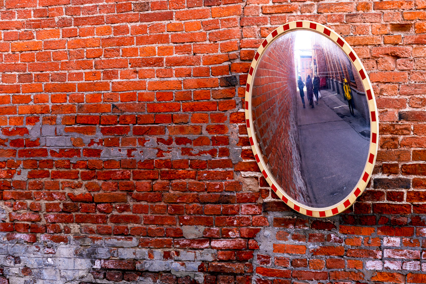 Spherical mirror on brick wall