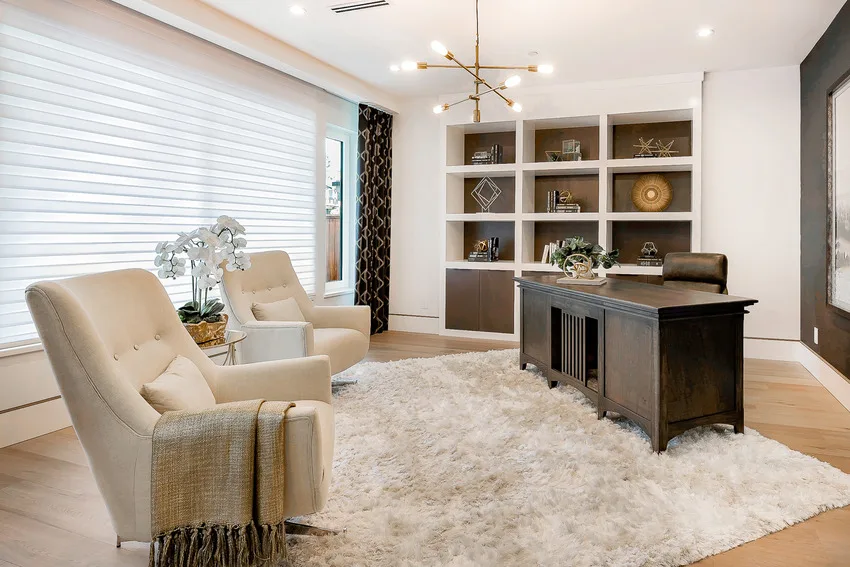 Stylish spacious home office interior with rug light fixture and armchair sofas