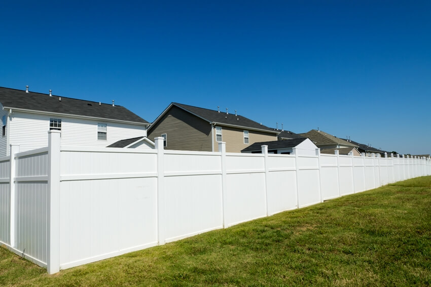 Suburban landscape with a long vinyl fence