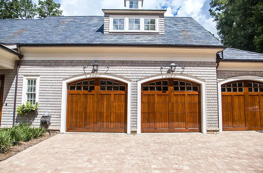 Three car home garage with wood doors