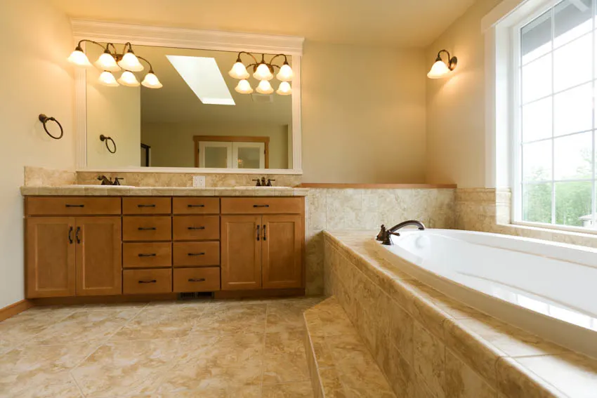 Travertine tub floor, wood drawer and cabinet mirror with lighting 