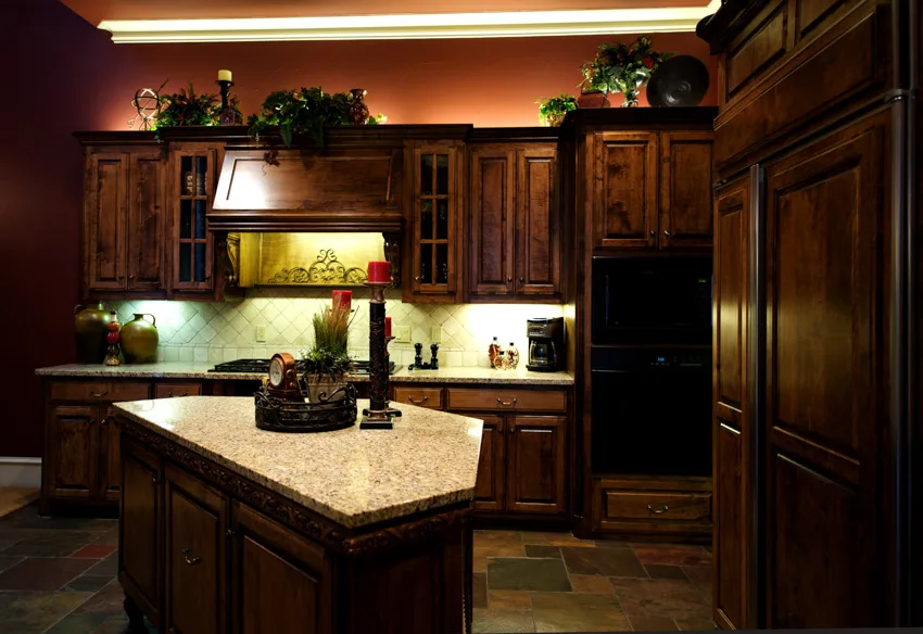 Tuscan kitchen with dark wood theme wooden cabinets center island marble countertop hood