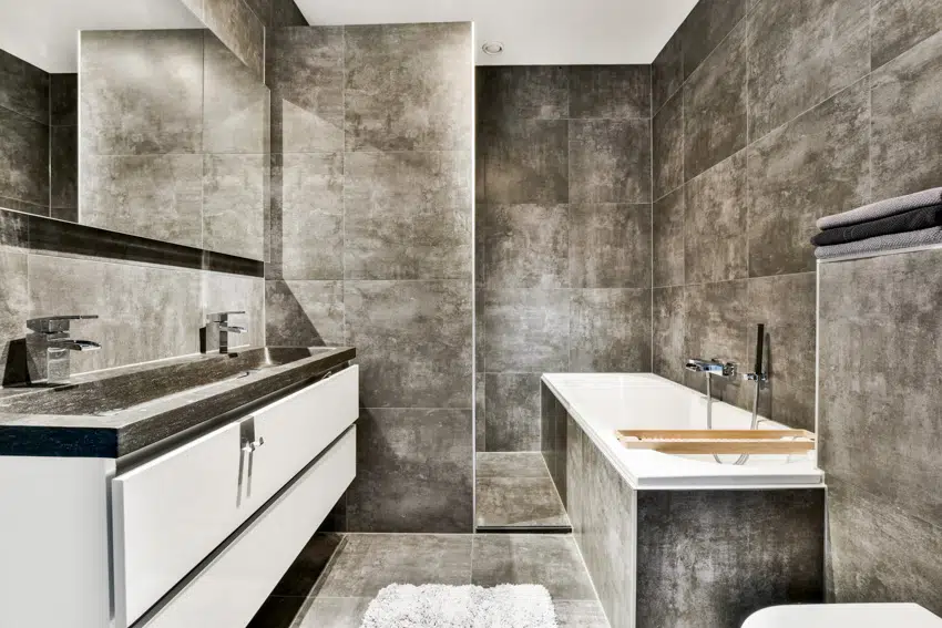 White and gray bathroom with countertop mirror bathtub