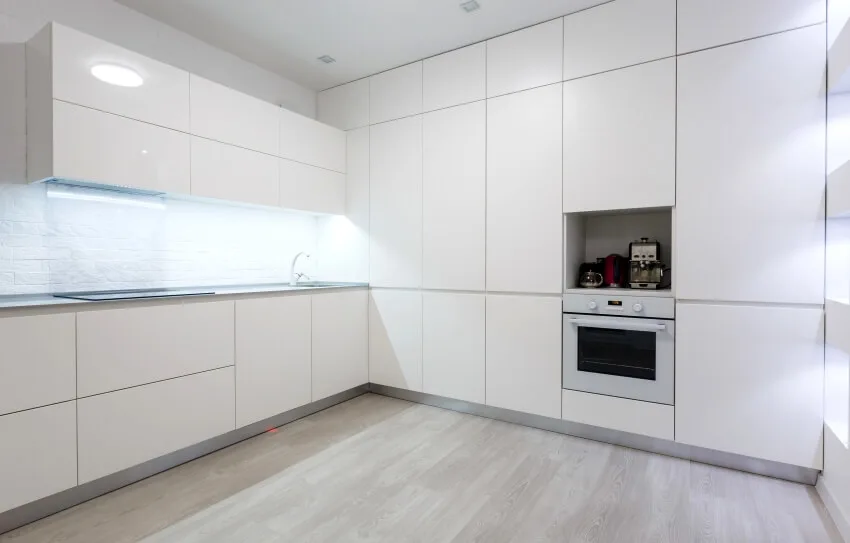 White modern kitchen interior with wooden floors