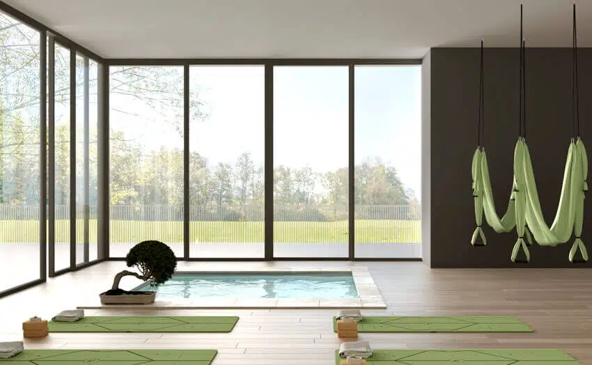 A yoga studio interior design minimal open space with mats hammocks and accessories spa pool and bonsai