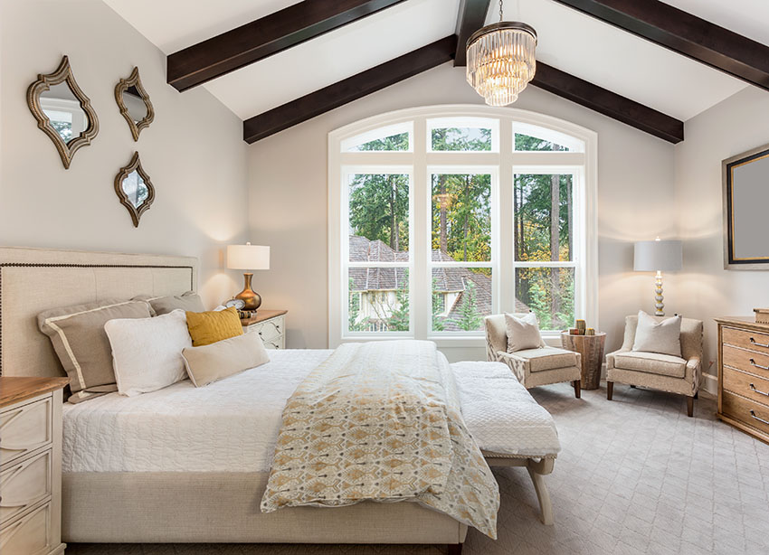 Bedroom with cathedral ceiling chandelier double hung windows