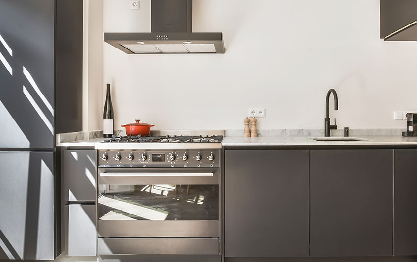 Modern kitchen with black cabinets black oven