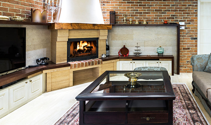 Living area with fireplace, brick wall and glass coffee table