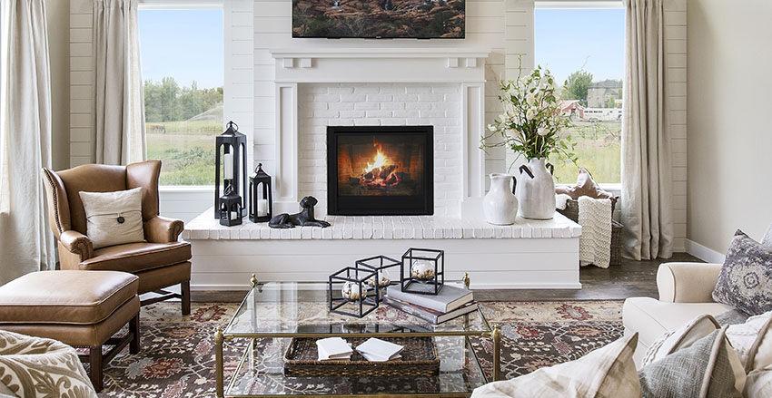 Living area with insert wood fireplace, white paint and leather arm chair