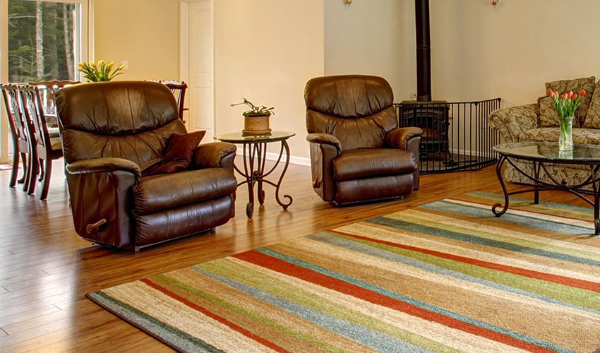 Living area with recliner sofa rug beige paint