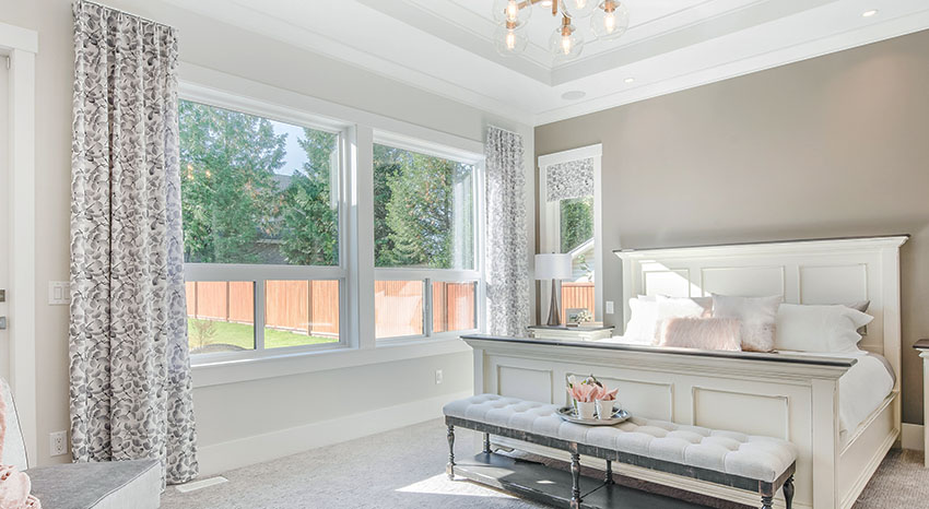 Modern farmhouse bedroom with gray paint and custom window