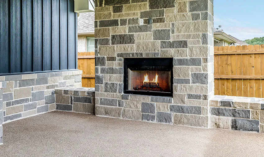 Outdoor gas fireplace with teal wood wall