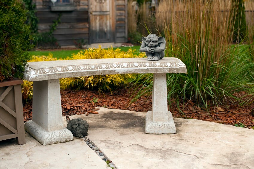 A stone bench in a back garden