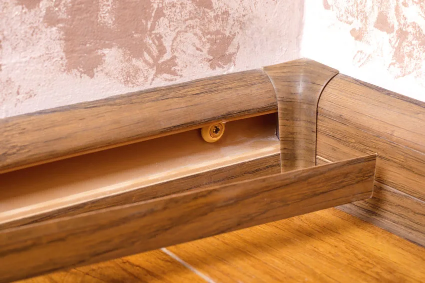 Baseboard with secret storage wood floor