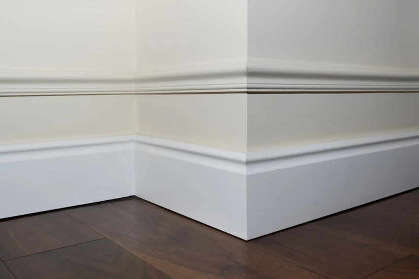 Baseboard with trim white wall wood floor