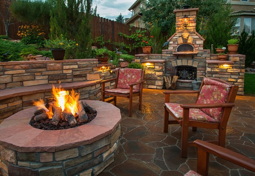 Beautiful backyard at twilight that includes a pizza oven and fire pit